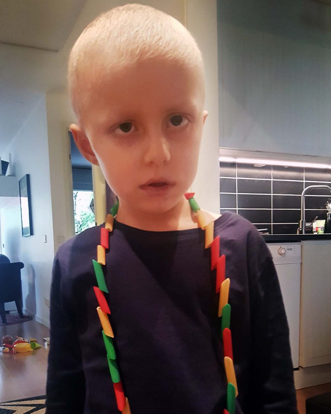 Elis med ett halsband han gjort av penne rigate-pasta