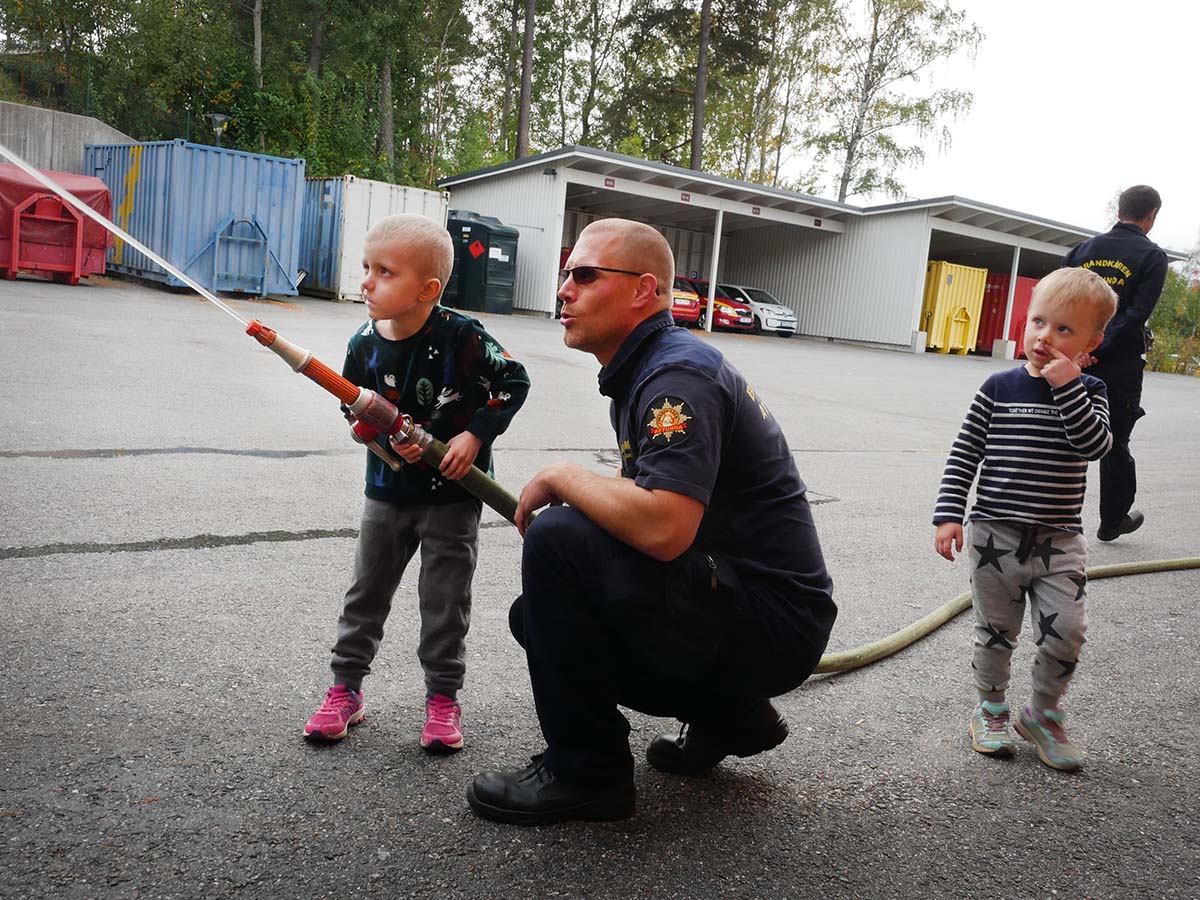 Elis provar att spruta med en brandslang, och Folke ser på